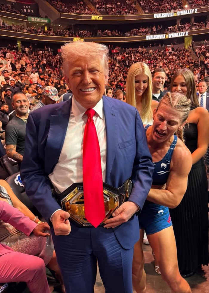 UFC Fighter Kayla Harrison putting her victory belt around President Donald Trump's waist, Photo Credit: TrendsWave/X