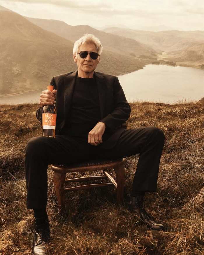 Harrison Ford holding a bottle of whiskey on top of a mountain, Photo Credit: lachlanbailey/Instagram