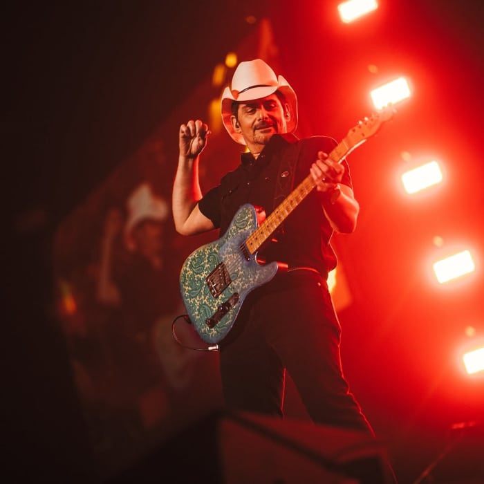 Brad Paisley holding a guitar on a stage, Photo Credit: bradpaisley/Instagram