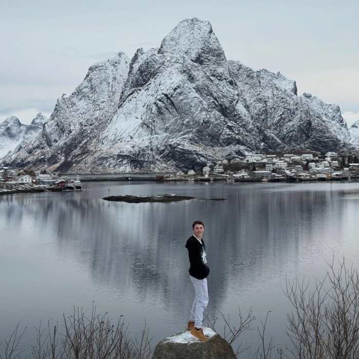 John Travolta's son Benjamin posing for a photo with a snowy mountain background, Photo Credit: johntravolta/X