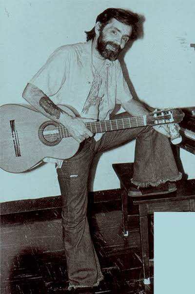 Charles Manson holding a guitar, Photo Credit: Paracetamol/X