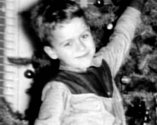 A young Ted Bundy standing beside a christmas tree, Photo Credit: DAN/X