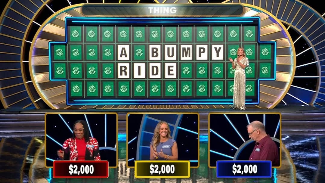 Wheel of Fortune host Vanna White with contestants solving a word puzzle, Photo Credit: wheelwatchershub/Instagram