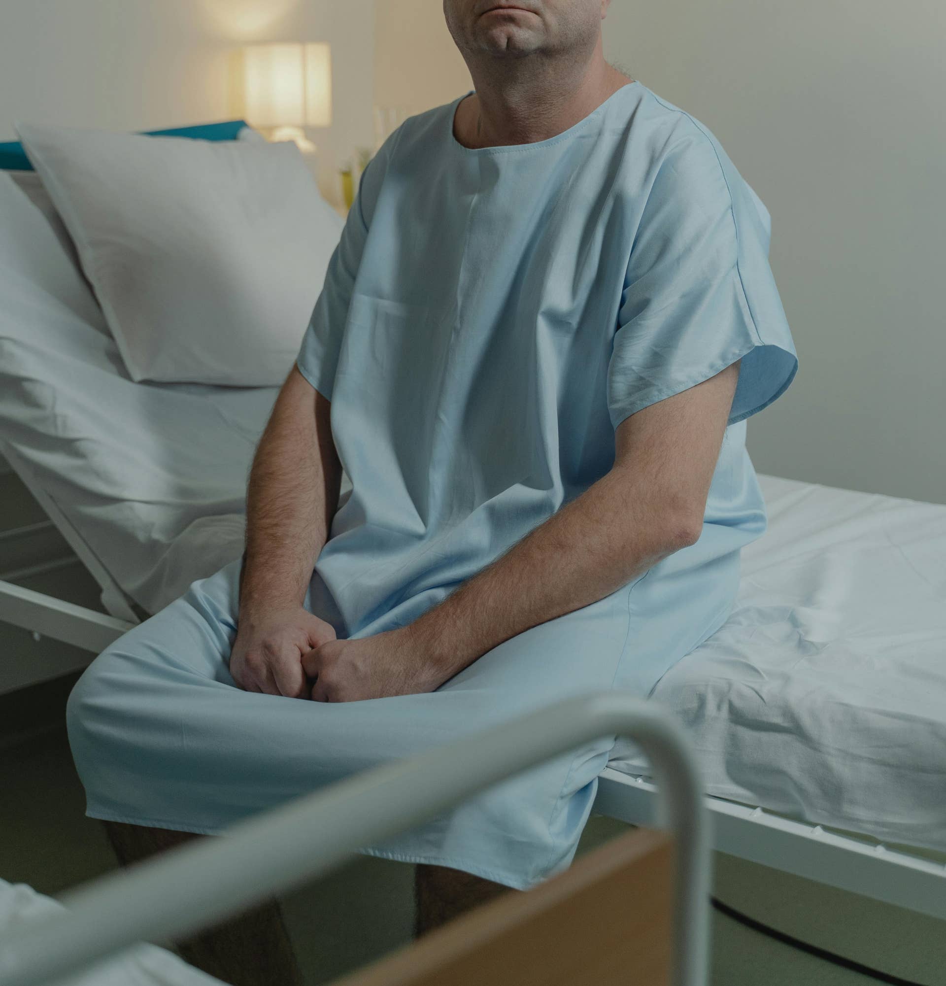 A man sitting on a hospital bed, Photo Credit: Pexels