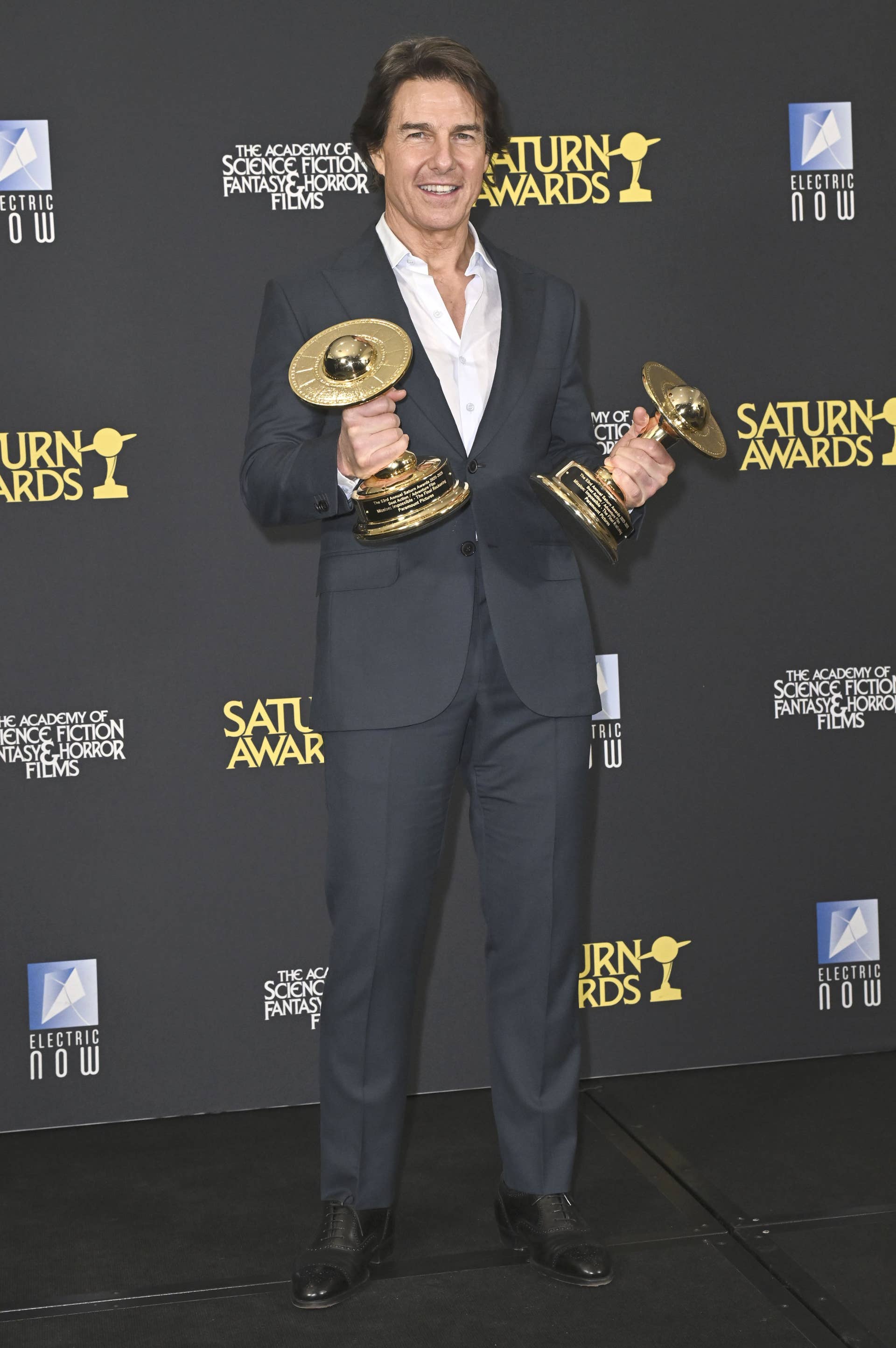 Tom Cruise holding two trophys at the Saturn Awards 2026, Photo Credit: hsufhkshndk11/X
