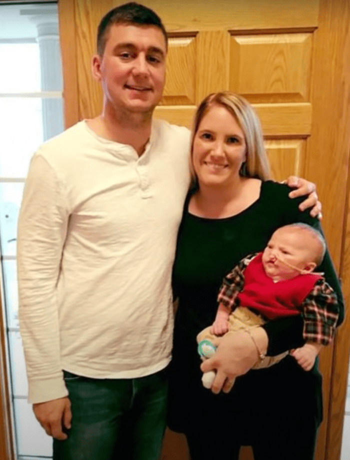 Sara Heller and her partner Chris Eidam holding their baby, Photo Credit: videoinspirational