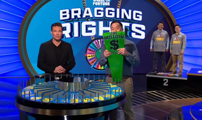 Show host Ryan Seacrest and contestant Sam Oh in a 'Wheel of Fortune' episode, Photo Credit: Wheel of Fortune/Youtube