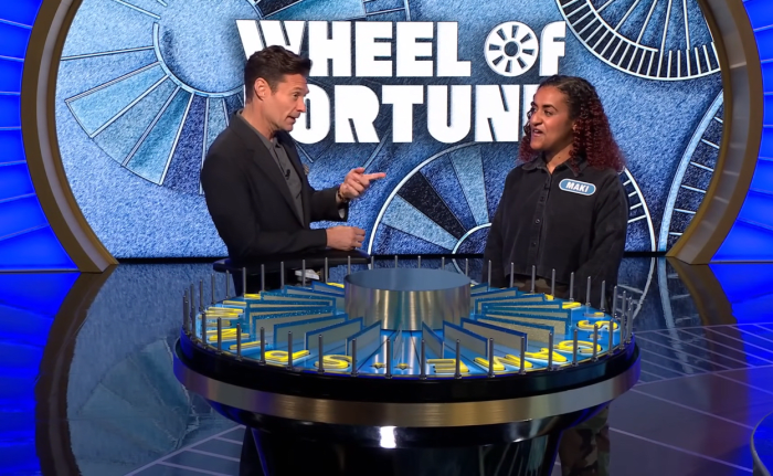 Show host Ryan Seacrest and contestant Maki Asrat in a 'Wheel of Fortune' episode, Photo Credit: Wheel of Fortune/Youtube