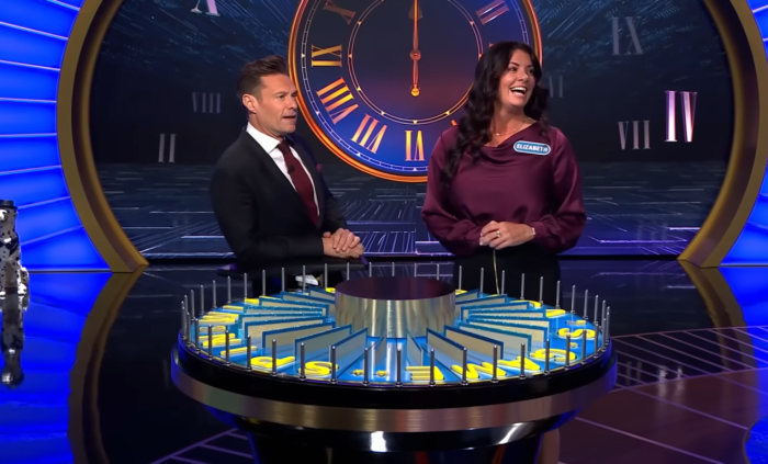 Show host Ryan Seacrest and contestant Elizabeth Caprini in a 'Wheel of Fortune' episode, Photo Credit: Wheel of Fortune/Youtube