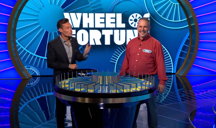 Show host Ryan Seacrest and contestant Eric Handzel in a 'Wheel of Fortune' episode, Photo Credit: Wheel Of Fortune/Youtube