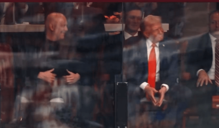 President Donald Trump's reaction to his son impersonating him while sitting in the crowd, Photo Credit: Fraser Jackson/X