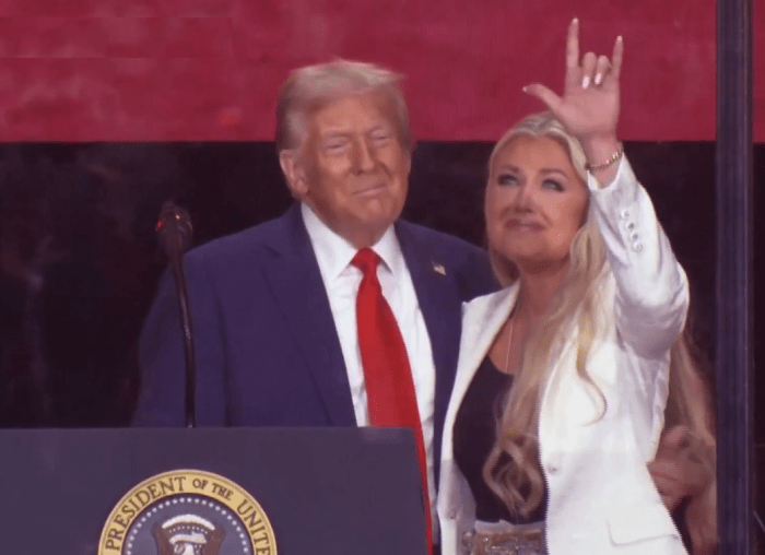 President Donald Trump standing with Erika Kirk who makes a hand gesture during Charlie Kirk's memorial, Photo Credit: WION/X