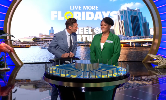 Show host Ryan Seacrest and contestant Cherie Noisette in a 'Wheel of Fortune' episode, Photo Credit: Wheel of Fortune/Youtube