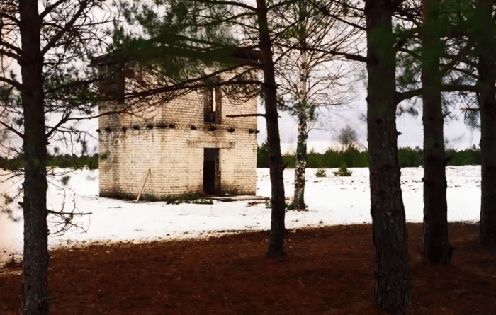 A house in a rural setting with a sniper hiding inside, Photo Credit: Лена Ловкая/Youtube