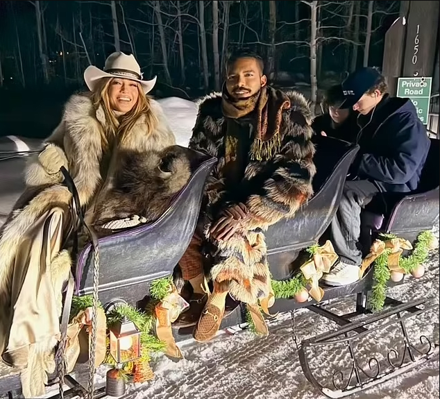 Jennifer Lopez with friends sitting on a sled in the snow, Photo Credit: jlo/Instagram
