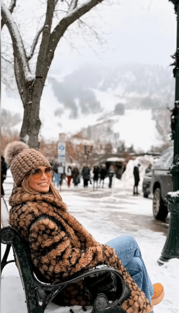 Jennifer Lopez sitting on a bench in the snow, Photo Credit: jlo/Instagram