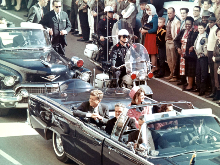 Former President John F. Kennedy and wife Jacqueline Kennedy in the motorcade minutes before his assassination in Dallas in 1963, Photo Credit: Wikimedia