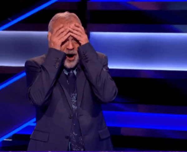 Wheel of Fortune UK host Graham Norton covering his face with his hands, Photo Credit: Wheel of Fortune UK/X