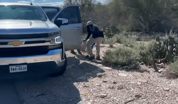FBI agents picking up a black glove on the roadside, Photo Credit: New York Post/Youtube