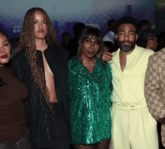 Malia Ann, formerly known as Malia Obama, posing with Childish Gambino and others at an event, Photo Credit: Entertainment Tonight/Youtube