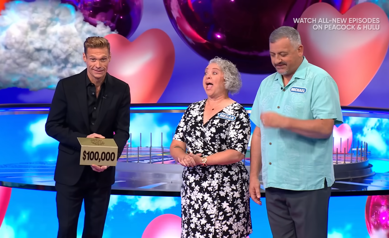 Show host Ryan Seacrest and contestants Megan and Michael Heiser in a 'Wheel of Fortune' episode, Photo Credit: Wheel of Fortune/Youtube