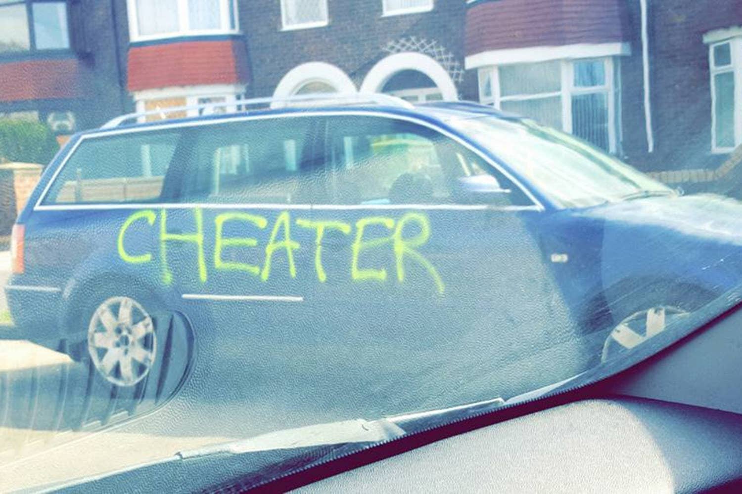 mans-car-branded-with-cheater-in-graffit