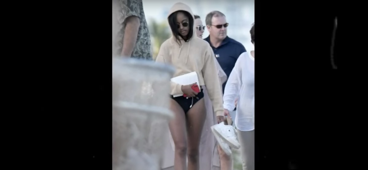 Closeup of Michelle Obama's daughter walking on the beach alongside her, Photo Credit: Youtube