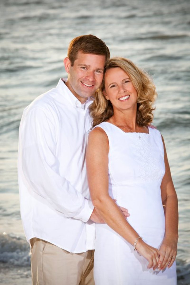 Carolyn and Sean Savage posing with each other in front of the ocean, Photo Credit: Carolyn & Sean Savage/Facebook
