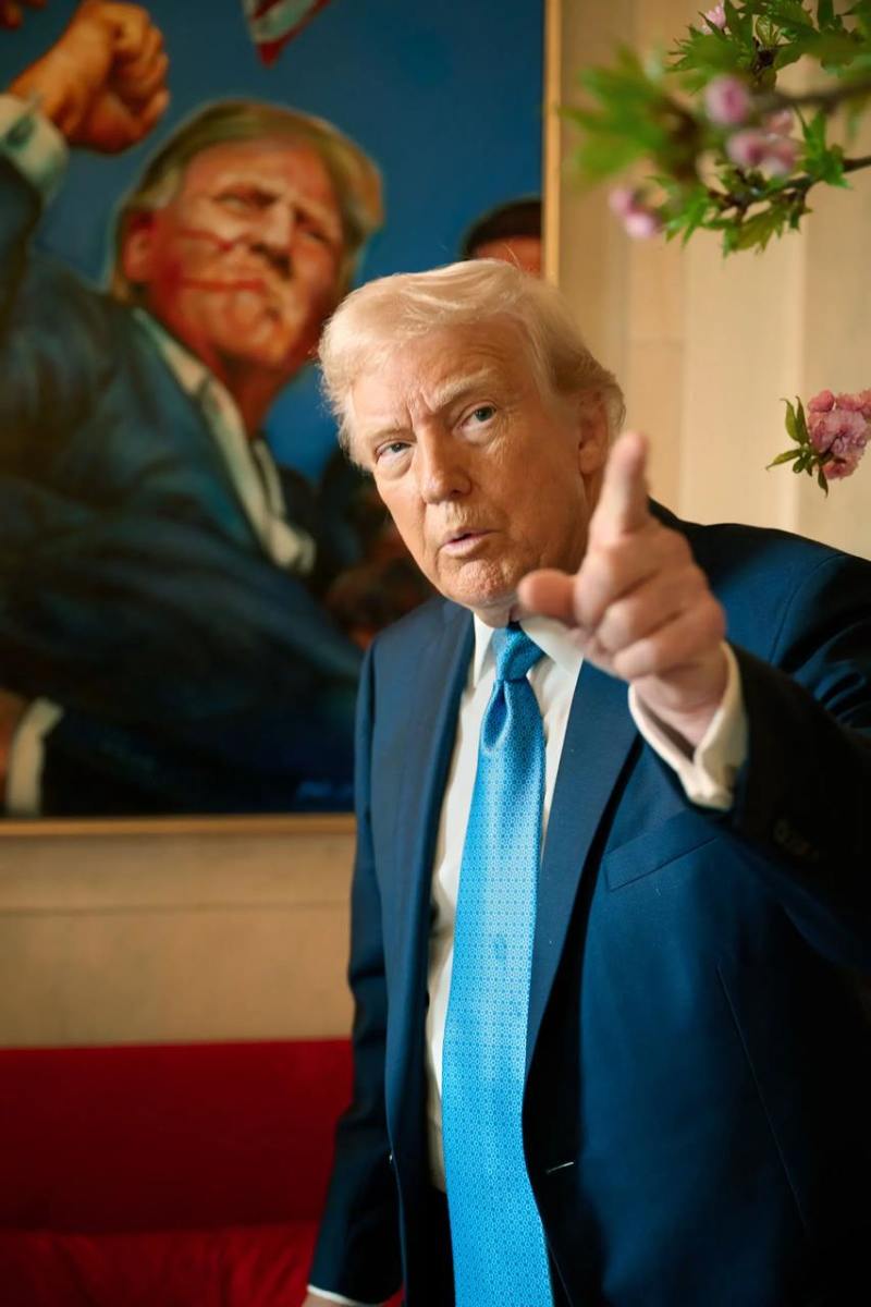 President Donald Trump in an interview with the backdrop of a portrait of him during the assassination attempt, Photo Credit: Sprinter Observer/X