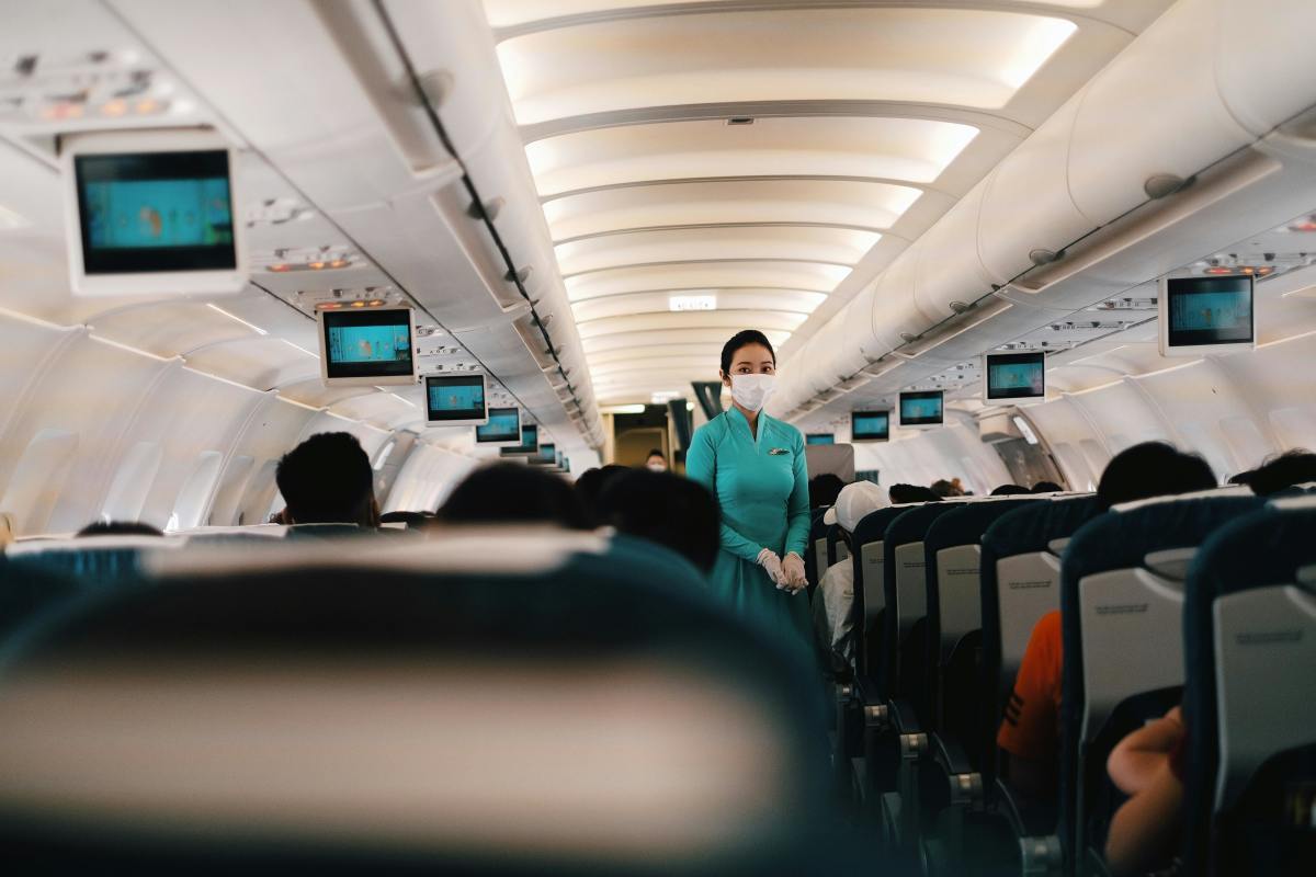 A Flight Attendant Standing in the Cabin, Photo Credit: Pexels