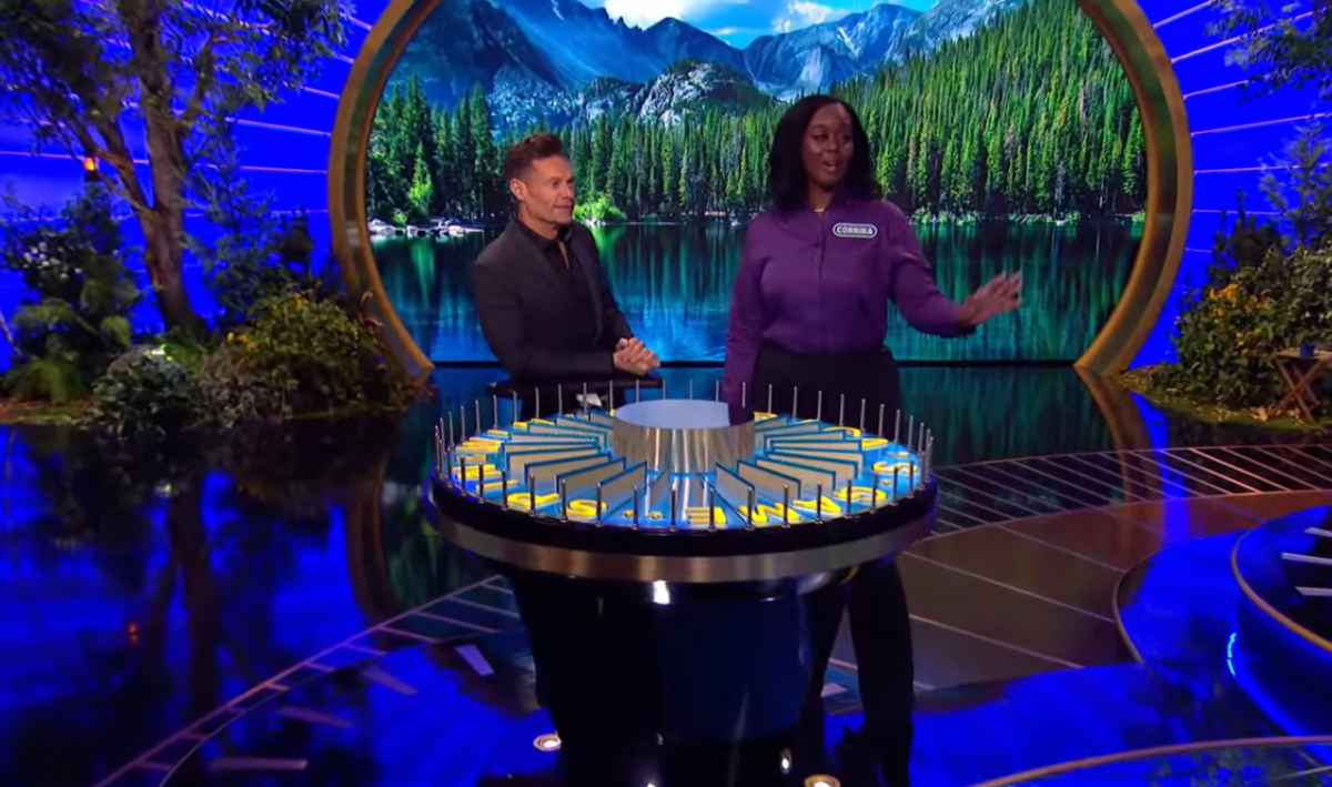 Show host Ryan Seacrest and contestant Corrina Bain in a 'Wheel of Fortune' episode, Photo Credit: Wheel Of Fortune/Youtube