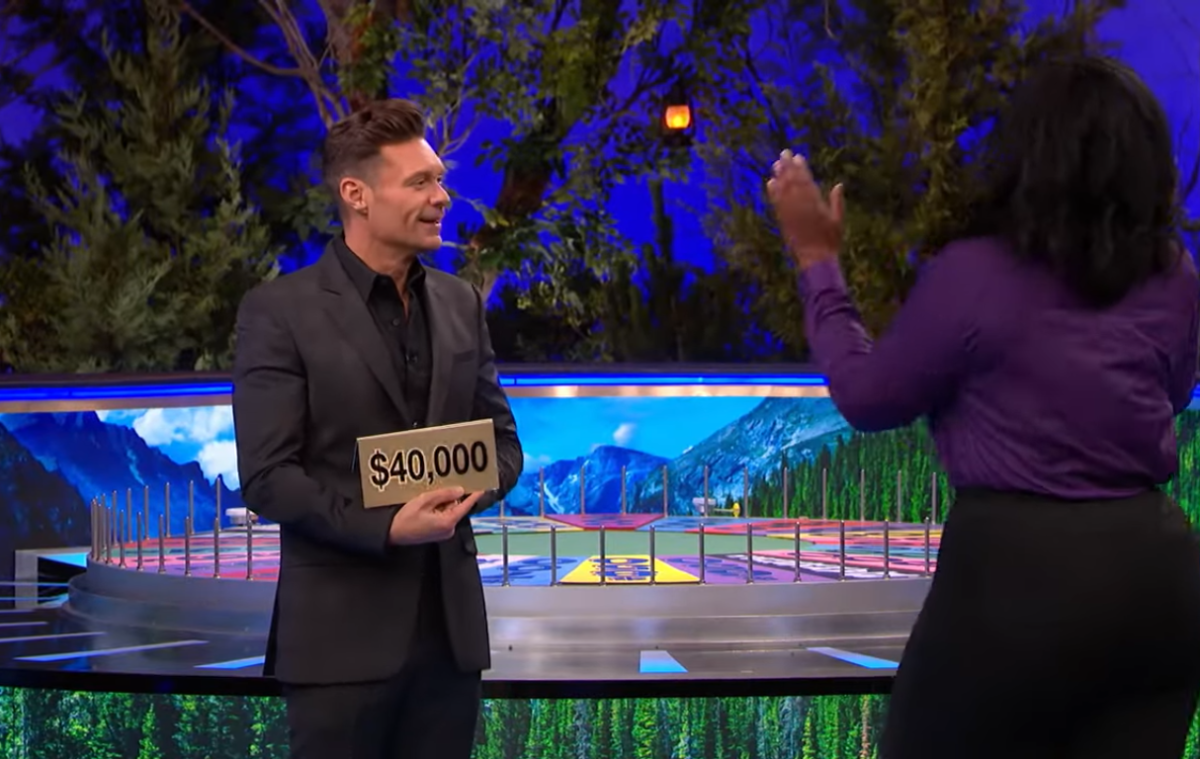 Show host Ryan Seacrest and contestant Corrina Bain in a 'Wheel of Fortune' episode, Photo Credit: Wheel Of Fortune/Youtube