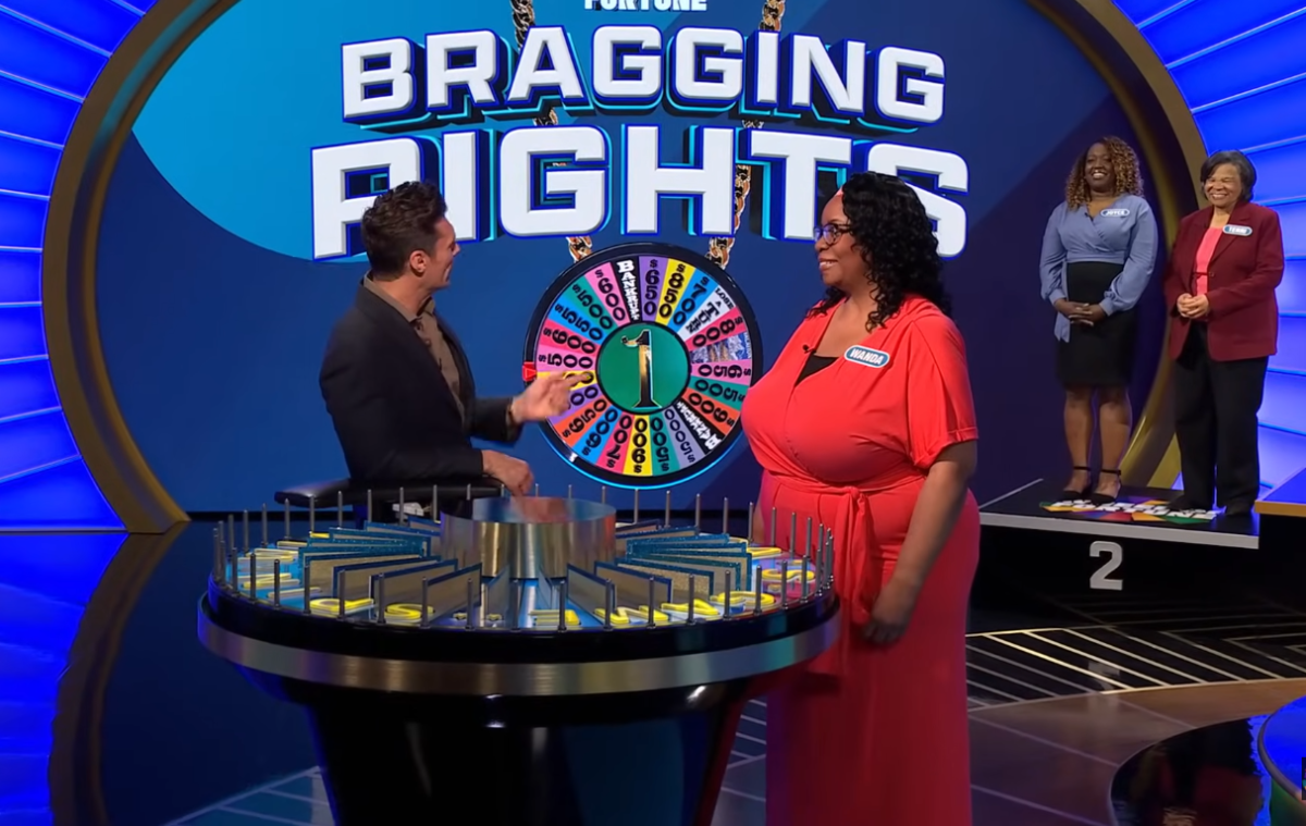 Show host Ryan Seacrest and contestant Wanda Ruff in a 'Wheel of Fortune' episode, Photo Credit: Wheel Of Fortune/Youtube