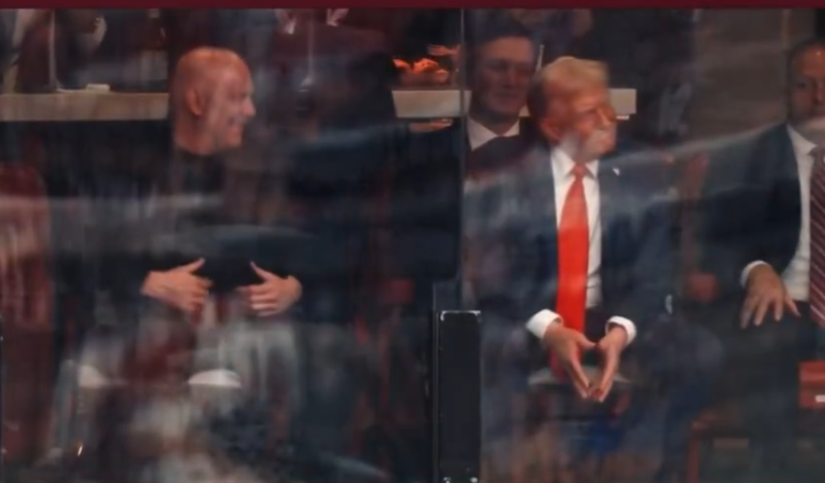President Donald Trump's reaction to his son impersonating him while sitting in the crowd, Photo Credit: Fraser Jackson/X