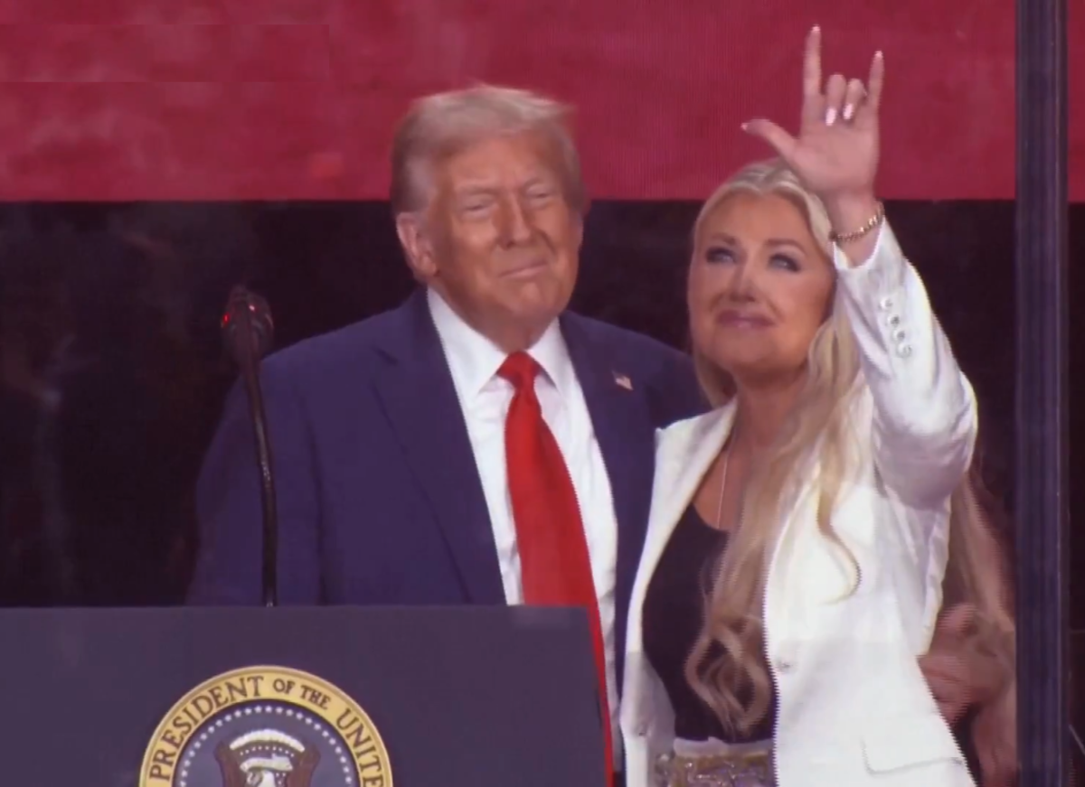 President Donald Trump standing with Erika Kirk who makes a hand gesture during Charlie Kirk's memorial, Photo Credit: WION/X