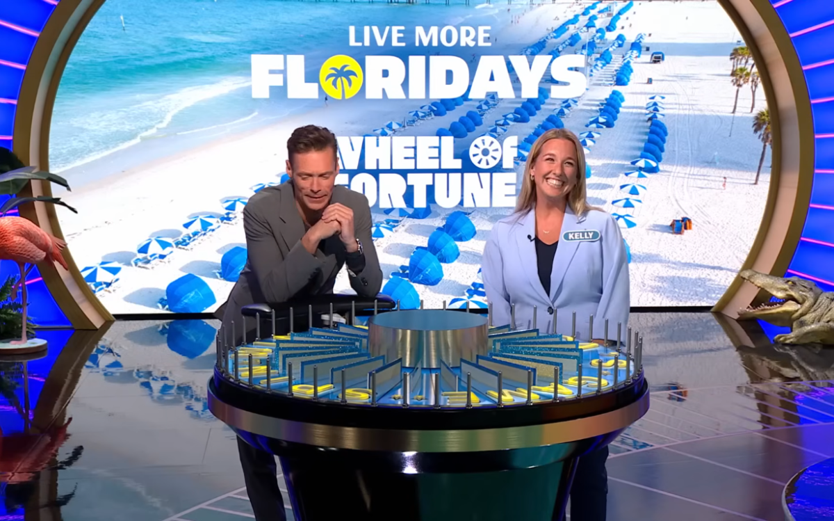 Show host Ryan Seacrest and contestant Kelly Amodio in a 'Wheel of Fortune' episode, Photo Credit: Wheel of Fortune/Youtube
