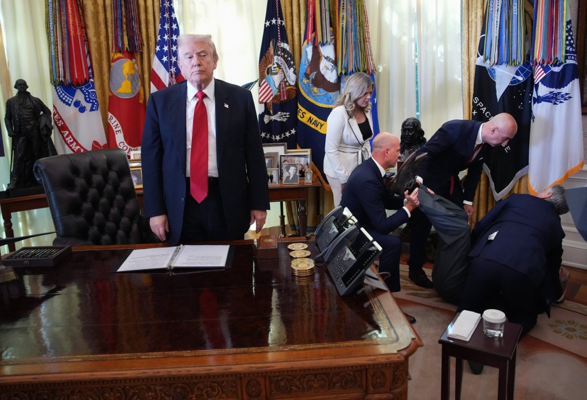 US President Donald Trump stands still as one of the attendees collapsed during the press conference at the White House, Photo Credit: Lauren/X