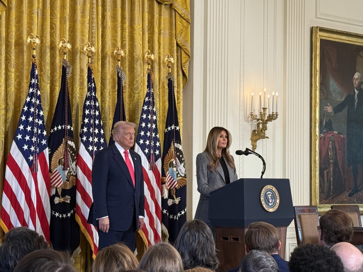 President Donald Trump standing beside his wife giving a speech, Photo Credit: Katelyn Caralle/X