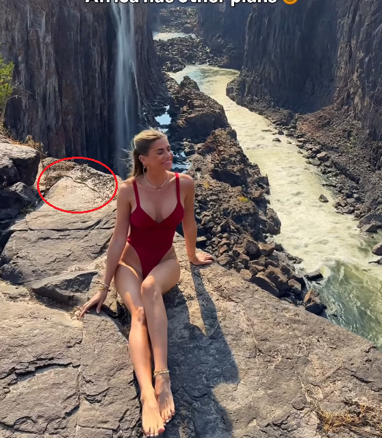 Jess Melu posing for a photo with the iconic Victoria Falls in the background and a snake behind her circled red, Photo Credit: jessmelu/Instagram