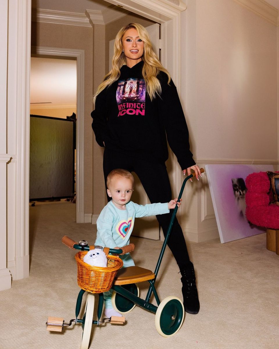 Paris Hilton with her son who's holding onto a toy bicycle, Photo Credit: parishilton/Instagram