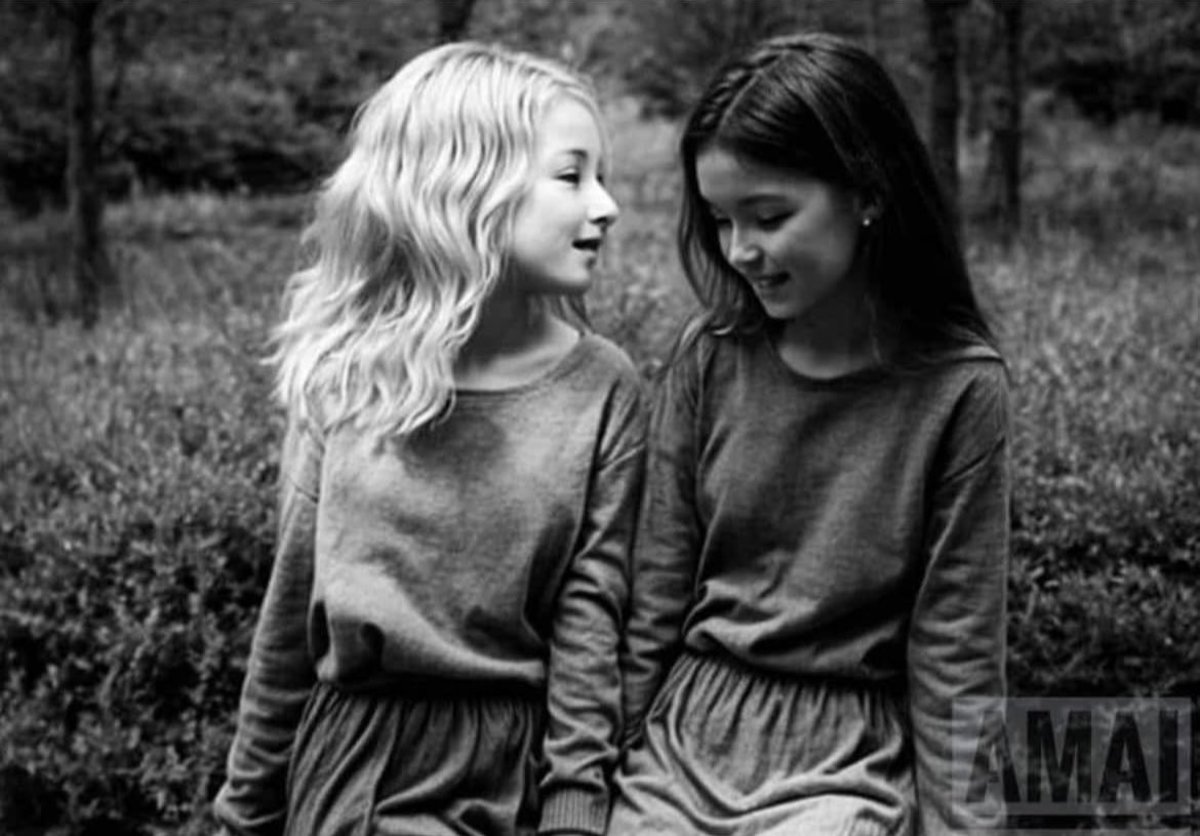 Optical illusion created by a photo of two young girls that appears like a woman's face when you squint, Photo Credit: The Redheaded libertarian/X