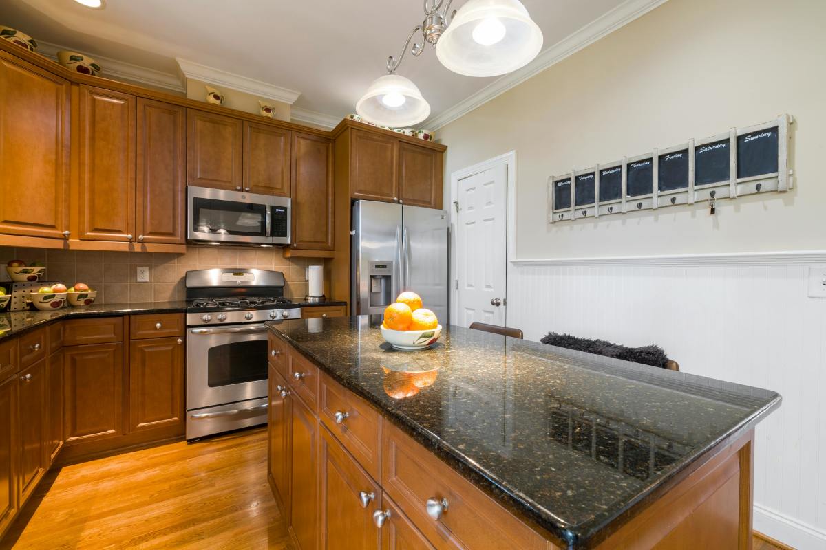 A kitchen with cupboards above the fridge (for illustrative purposes), Photo Credit: Pexels