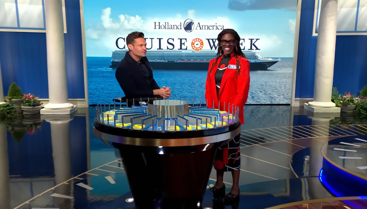 Host Ryan Seacrest standing next to contestant Traci Demus-Gamble, Photo Credit: Wheel of Fortune/Youtube