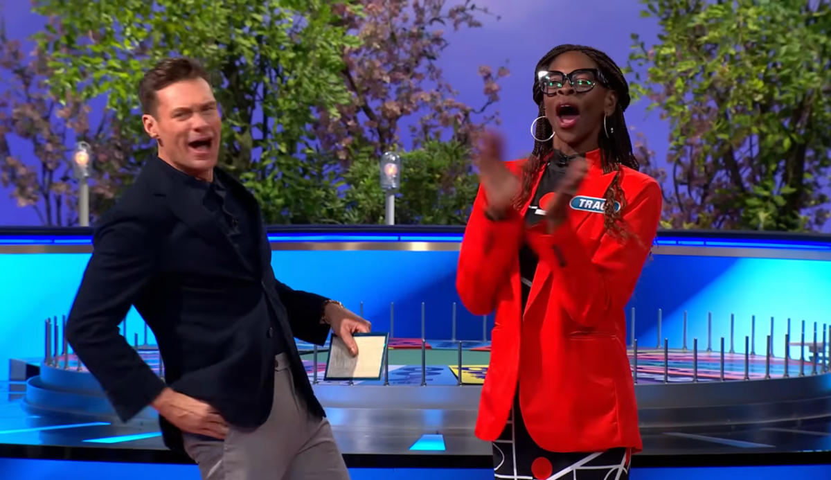 Host Ryan Seacrest standing next to a celebratory Traci Demus-Gamble, Photo Credit: Wheel of Fortune/Youtube