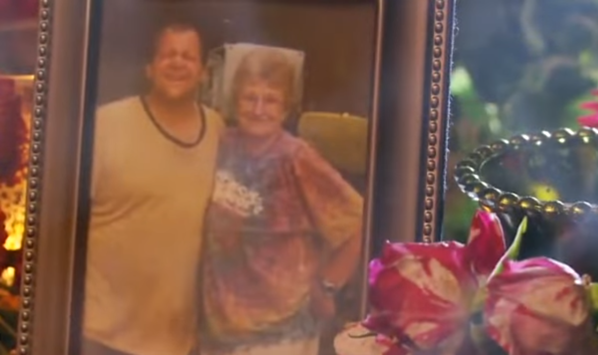 A photoframe of a man and and old woman, Photo Credit: Your Living Manna/Youtube