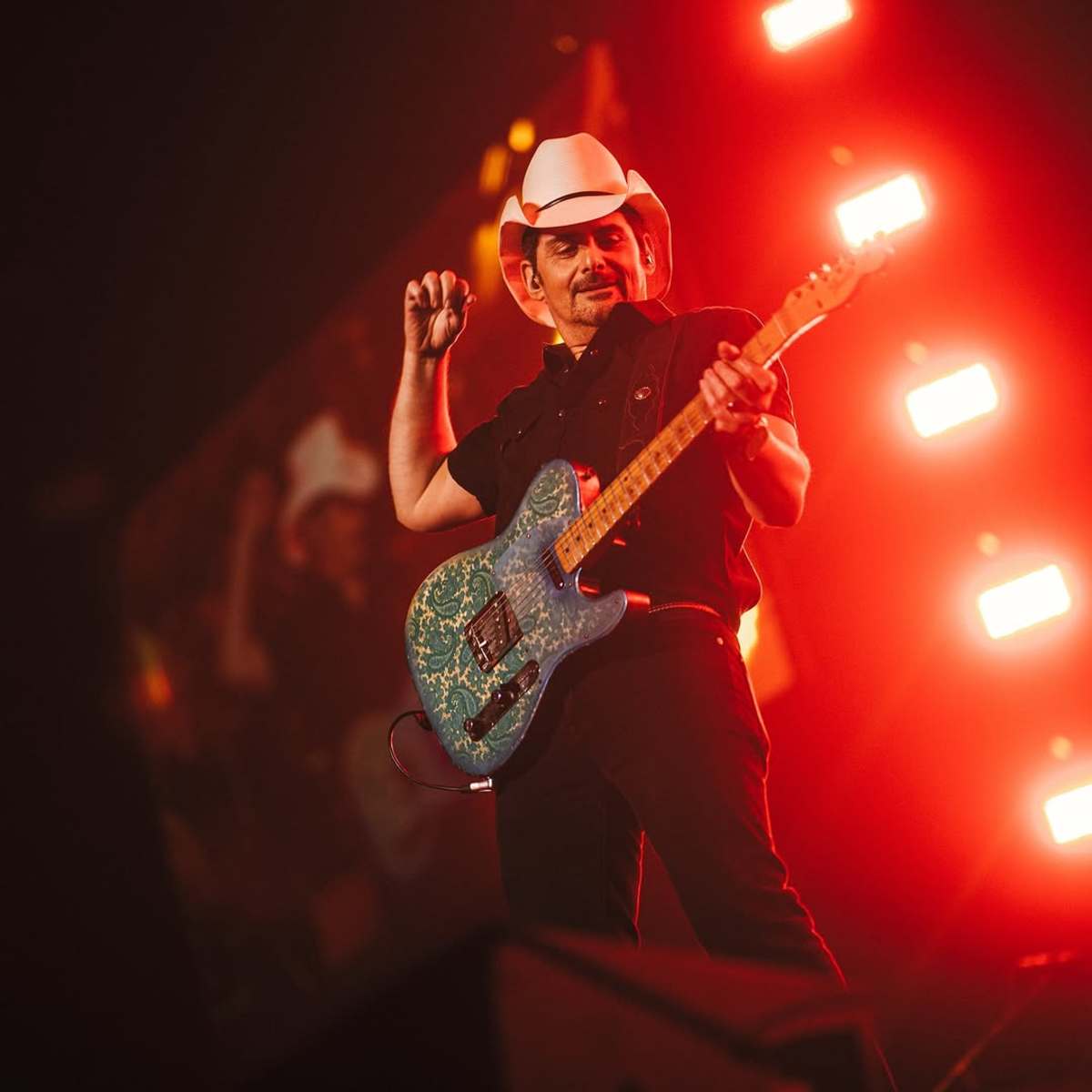 Brad Paisley holding a guitar on a stage, Photo Credit: bradpaisley/Instagram