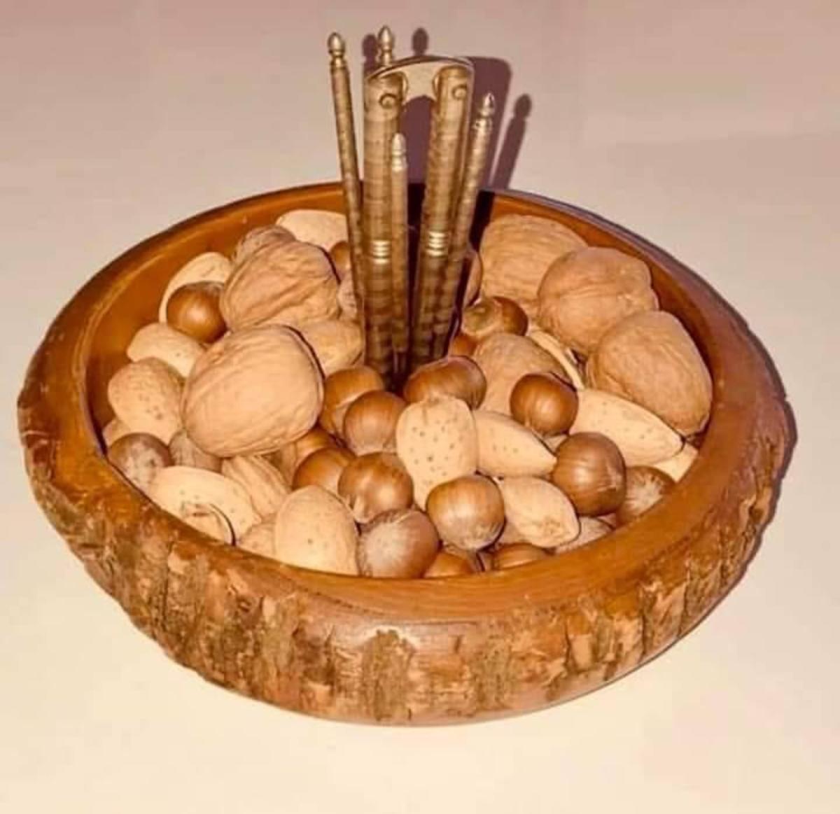 Walnuts on a table with the nut cracker in a bowl, Photo Credit: Reddit