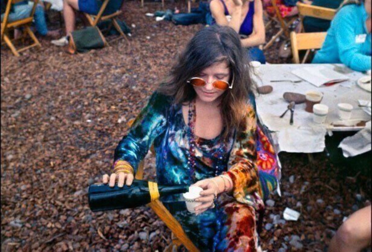 Janis Joplin pouring a drink backstage at Woodstock, August 1969, Photo Credit: Classic Rock In Pics/X