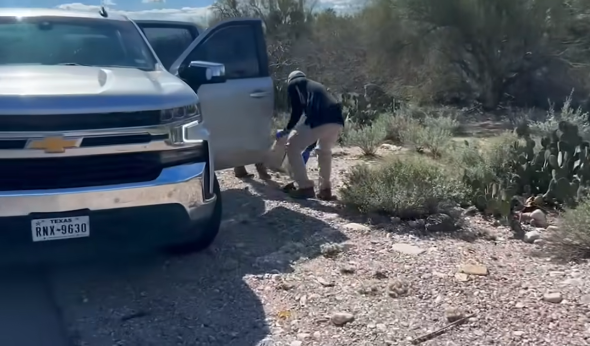 FBI agents picking up a black glove on the roadside, Photo Credit: New York Post/Youtube
