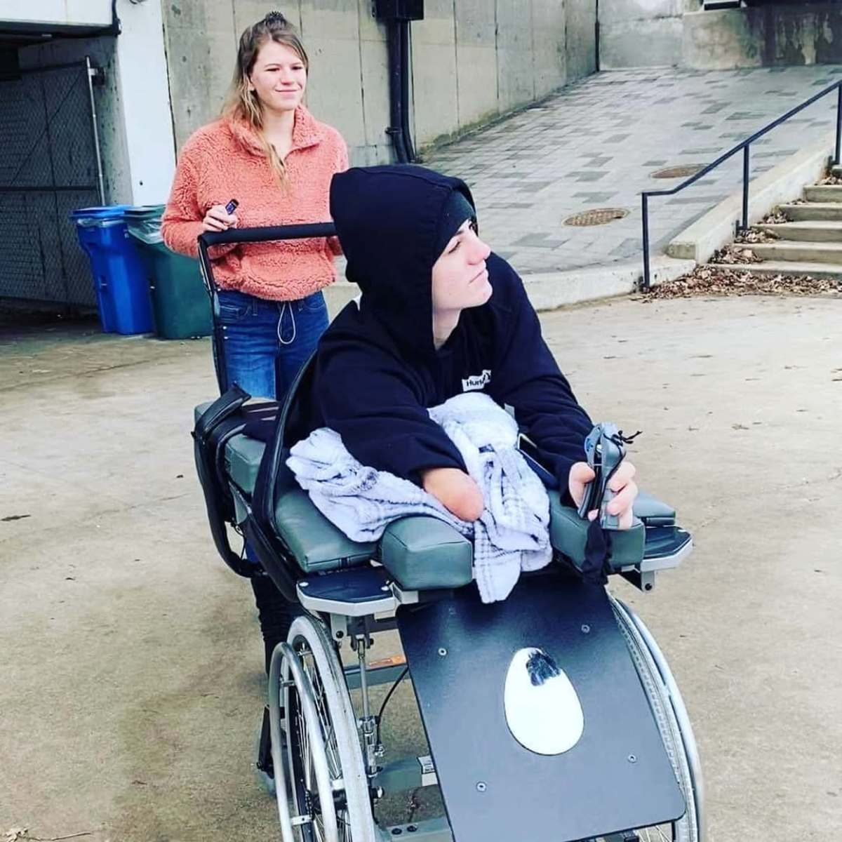 Loren sitting on a wheelchair with Sabia behind him, Photo Credit: loren.schauers/Instagram